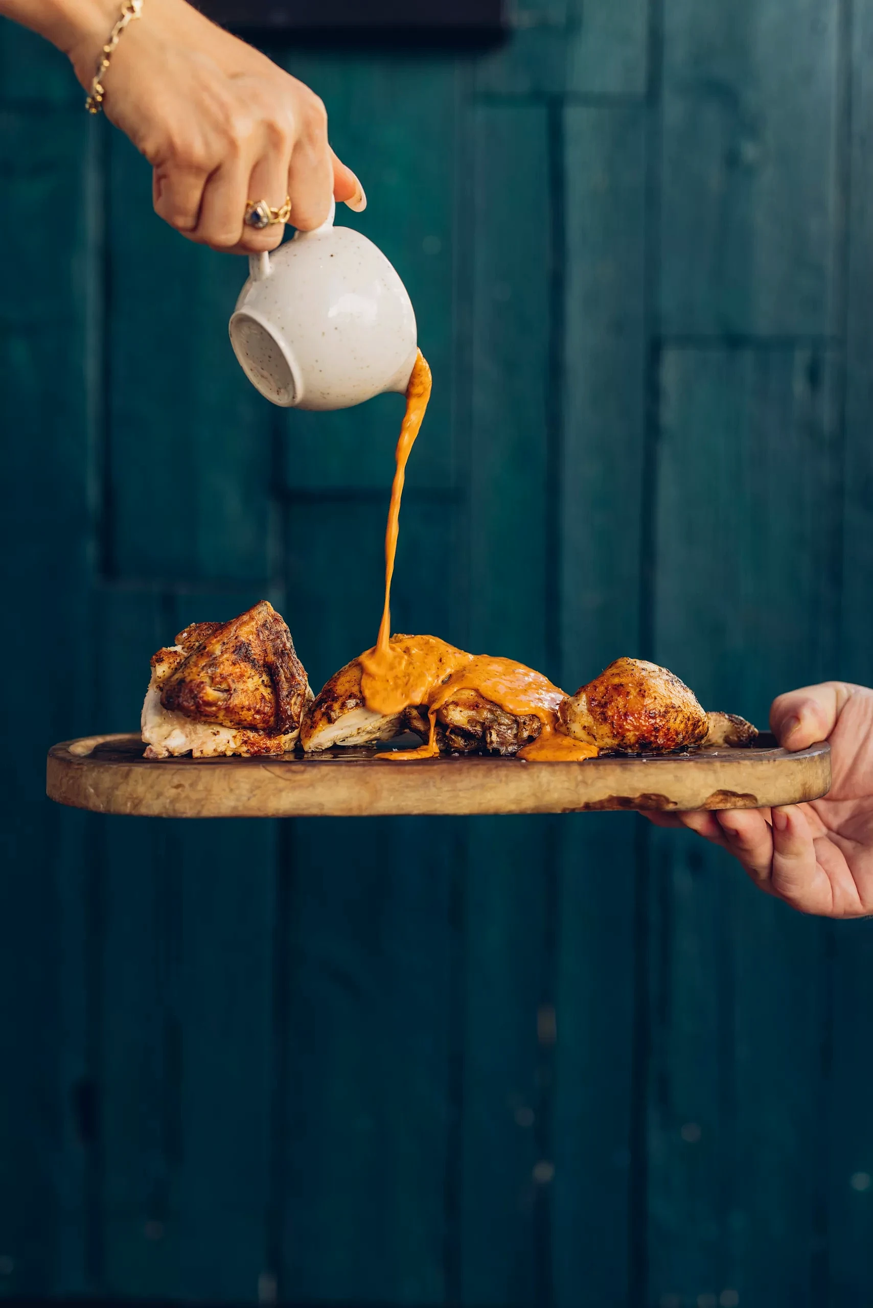 Cocotte's Secret Sauce poured on grilled chicken